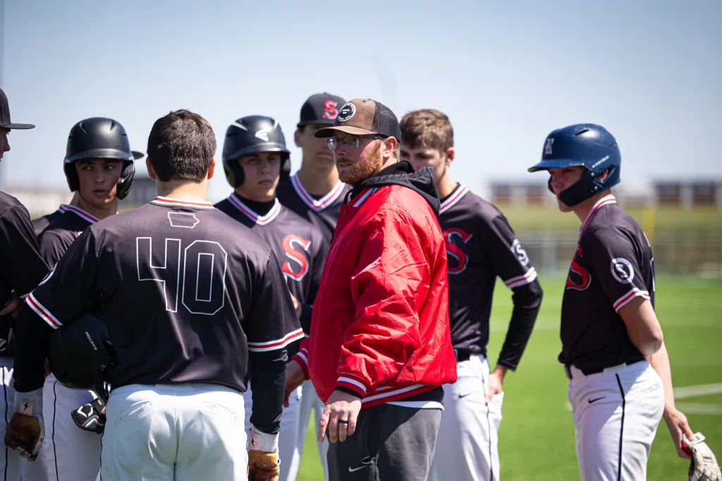 Coach huddling with team